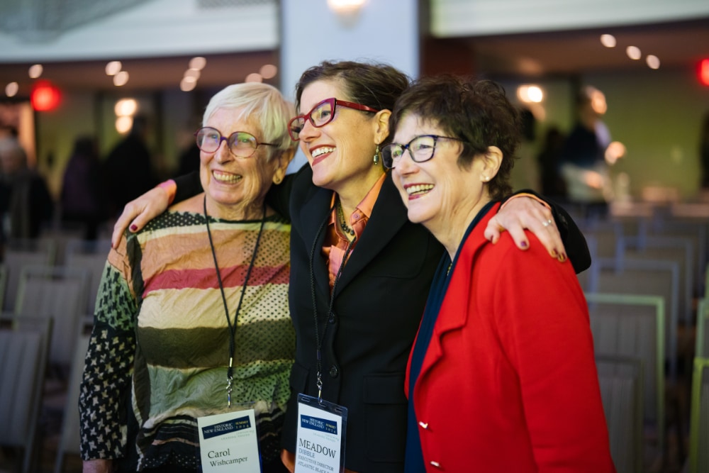 Three attendees at the 2024 Historic New England Summit posing for a picture, smiling.