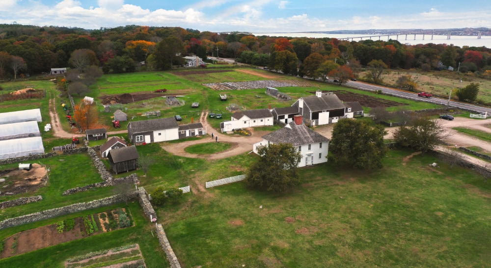 An aerial photo of Casey Farm. Large fields, a road, and the buildings of the property are visible.