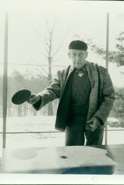 Walter Gropius playing table tennis on the porch of Gropius House