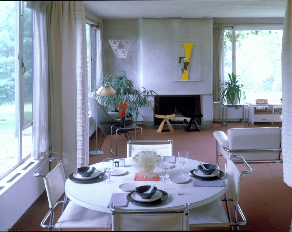 A photo showing a set dining room table inside of Gropius House.