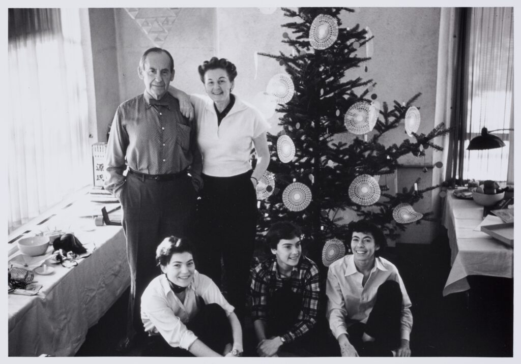 A black and white photo showing the Gropius family posing in front of a Christmas tree.