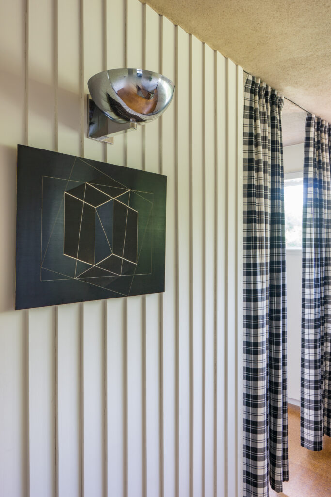 A photo of a wall in Gropius House with artwork.