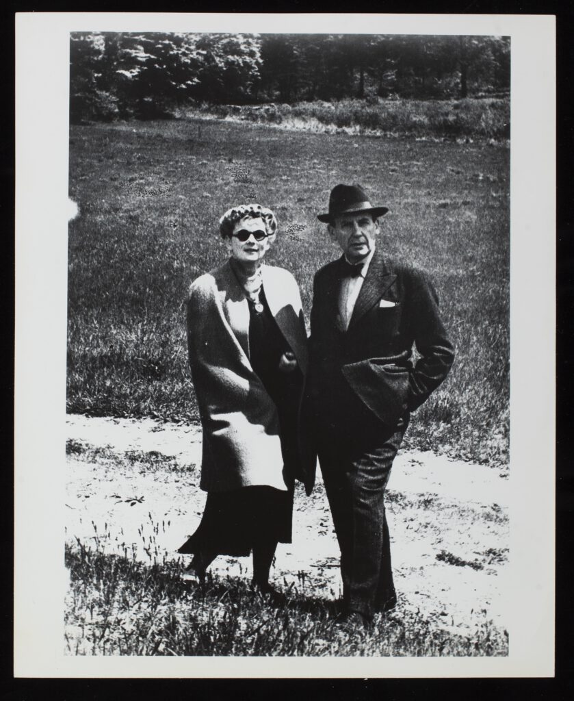 A black and white photo of Walter and Ilse Gropius standing outside.