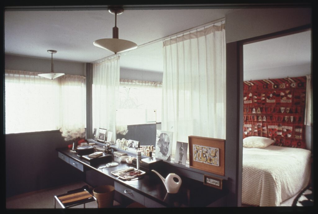A photo of a long table underneath two ceiling lamps.