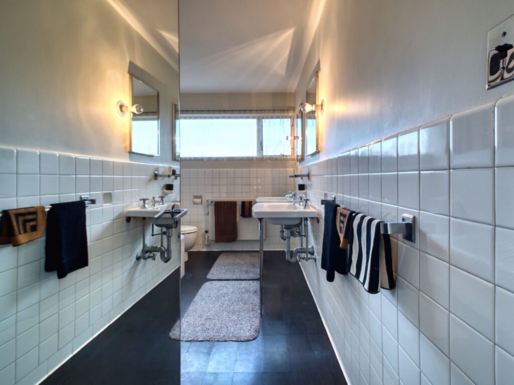 A photo of the master bathroom showing towel racks along a hallway.