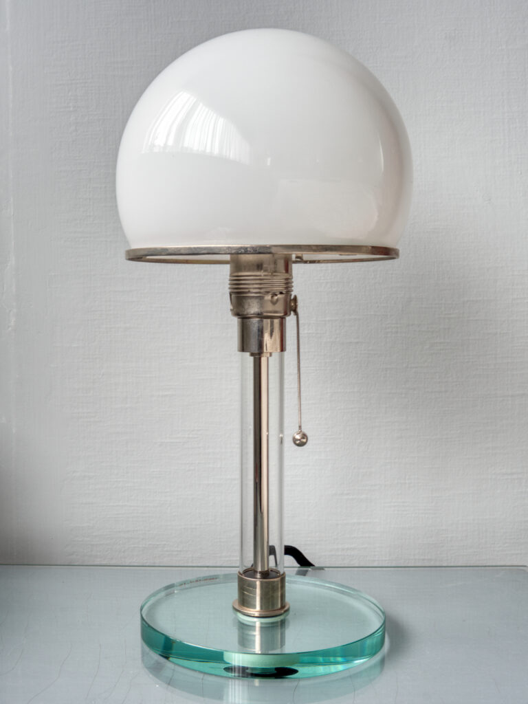 A glass desk lamp with a rounded shade.