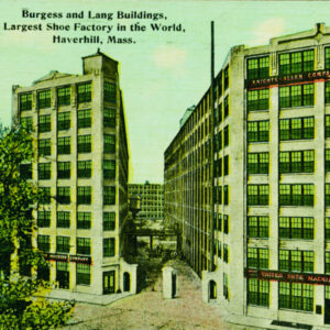 Two eight-story concrete buildings with large windows stand parallel to each other, with a conveyor belt visible in between them. Signs on the buildings read, Knights-Allen Company Turn Shoes and United Shoe Machinery Company.