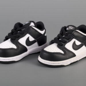 A pair of small white and black toddler sized sneakers in a three-quarters profile.