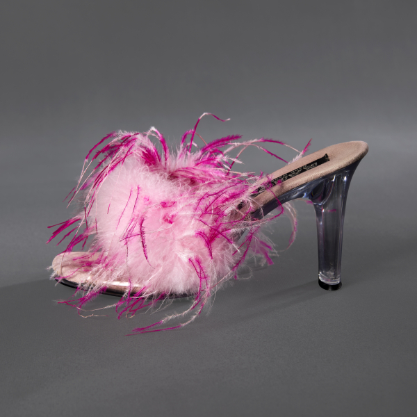 A high-heeled shoe with no back straps and one thick strap across the front of the foot. The strap is covered in skinny, fluffy feathers that are light pink with dark pink and white tips.