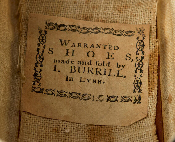 A label inside of a shoe reads, “Warranted shoes, made and sold by I. Burrill, In Lynn.” 