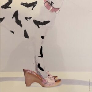A dalmatian wearing a pair of pink shoes and a pink collar. The dog's spots are shoe-shaped.