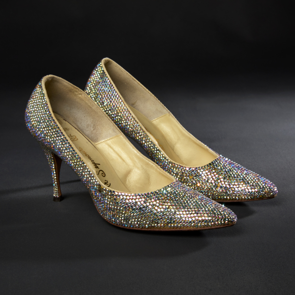 A pair of sparkly rhinestone pumps. The rhinestones glisten with multiple colors as they reflect the light.