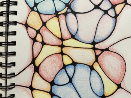 A spiral bound journal page filled with an abstract geometric design.