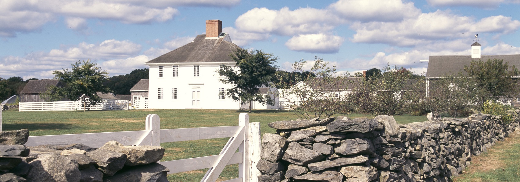 Farmhouse, barn, and stone wall at Casey Farm