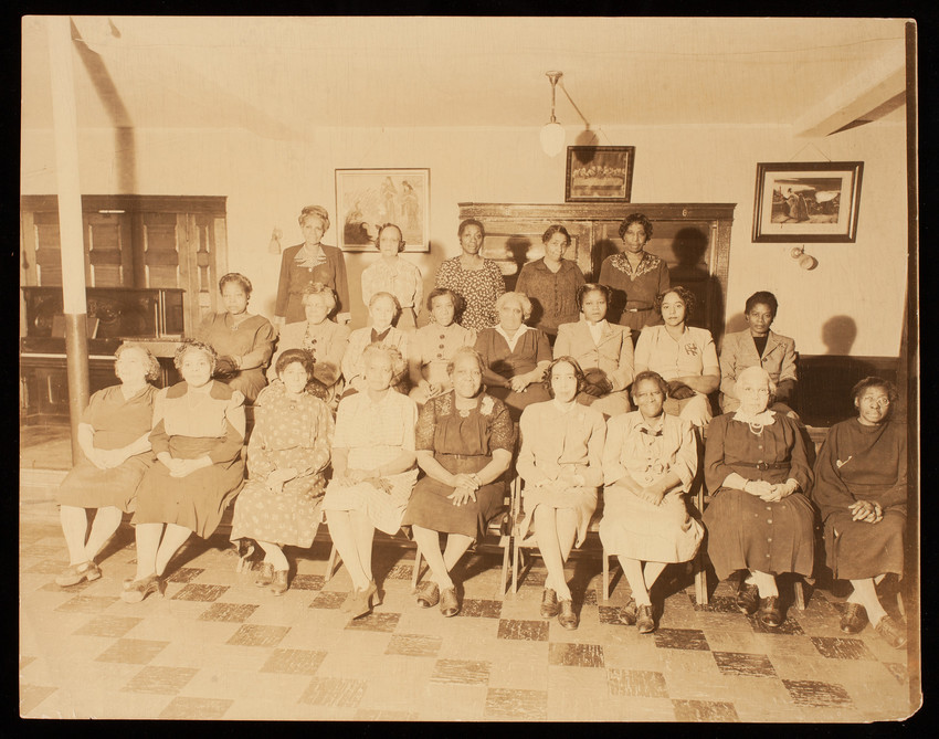Group of women sit for a photo in a room at the Ebenezer Baptist Church