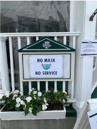 A sign posted outside a local business reads, "No mask, no service."
