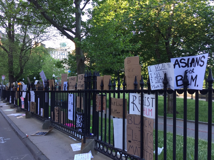 Signs from a Black Lives Matter protest in response to George Floyd's murder line a fence in downtown Boston.
