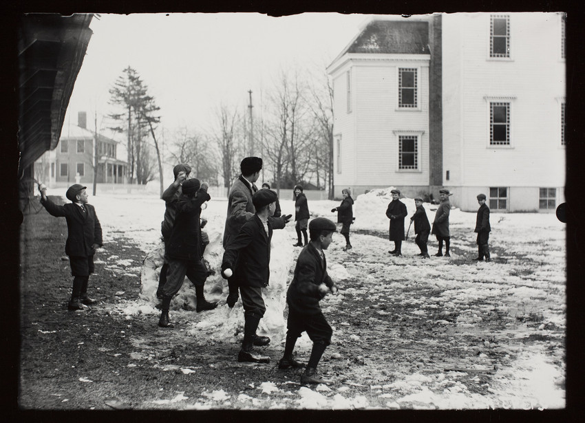 In a neighborhood of Shrewsbury, Massachusetts, a group of boys and teenagers are engaged in a snowball fight in front of the Intermediate School.