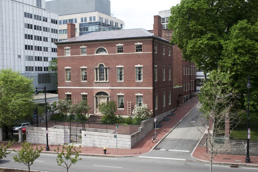 Brick Federal-style Otis House and two connected row house. Taken from across the street. 20th century building in the background.