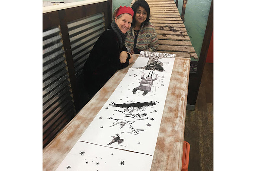 Artists looking at drawings for RainKeep
