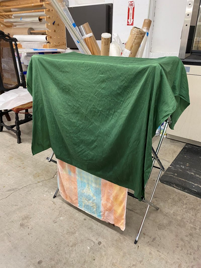 Dyed silk textile hanging to dry.
