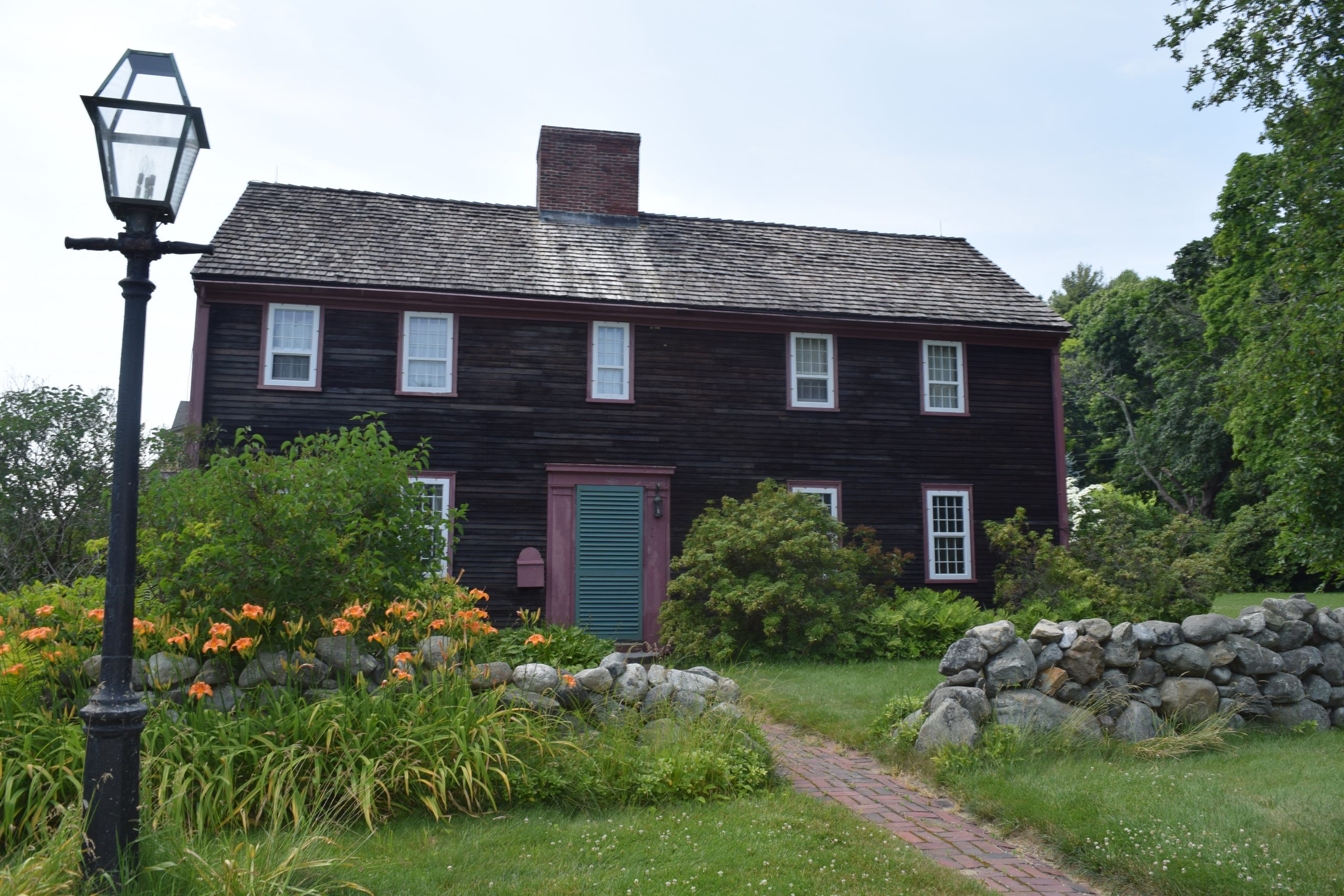 Exterior of Seddon Tavern, with a small stone wall and lantern out front.