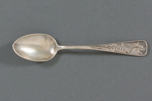 Silver souvenir spoon with witch and pins