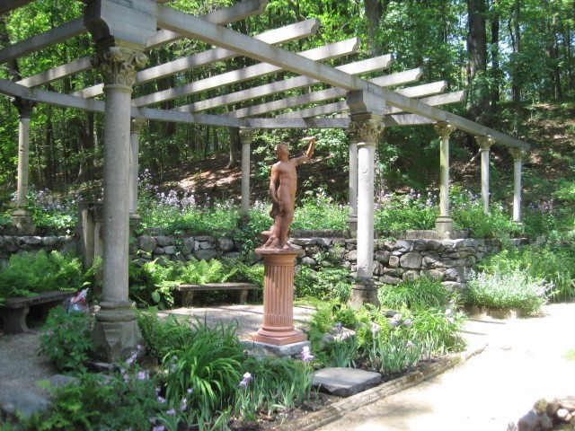 Lush Italian style garden with statue of Bacchus