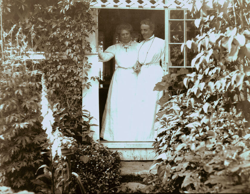 Two women, Emily Tyson and Sarah Orne Jewett, standing in the Hamilton House doorway.
