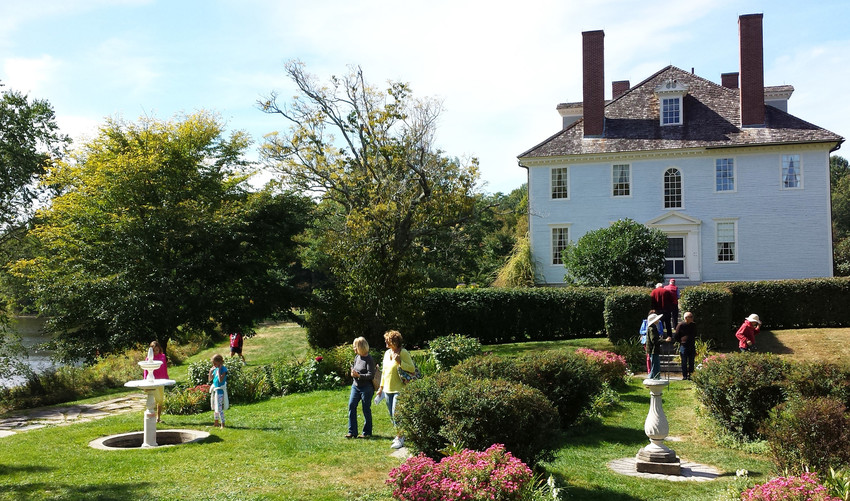 People in outdoor parterre garden in front of Hamilton House