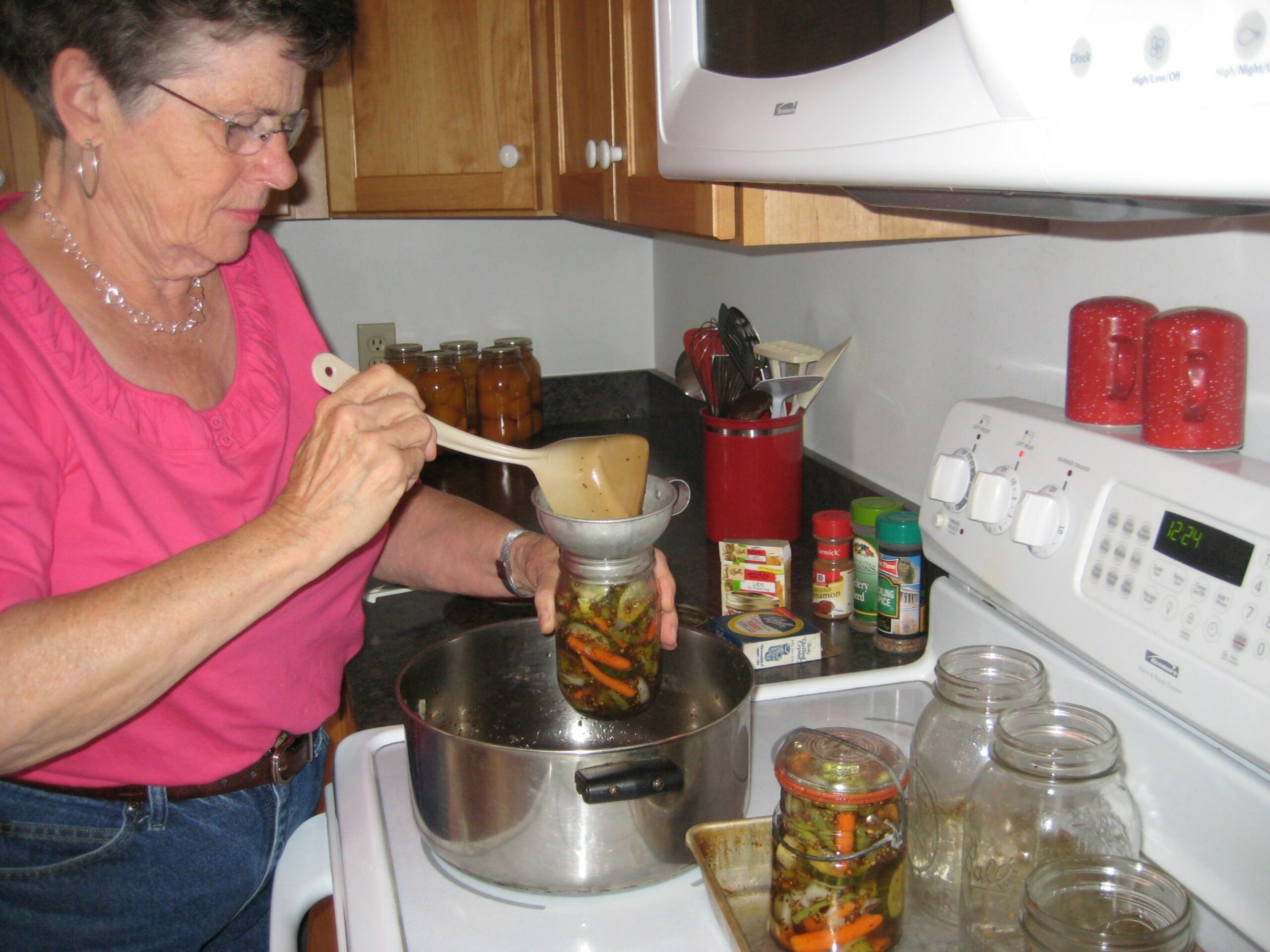 Caroline Craig in the caretaker's kitchen at Cgswell's Grant canning vegetables.