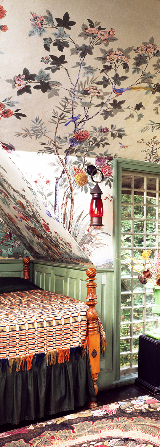 Colorful wallpapered alcove with plant and bird motif. Frame by green paianted window and paneling.