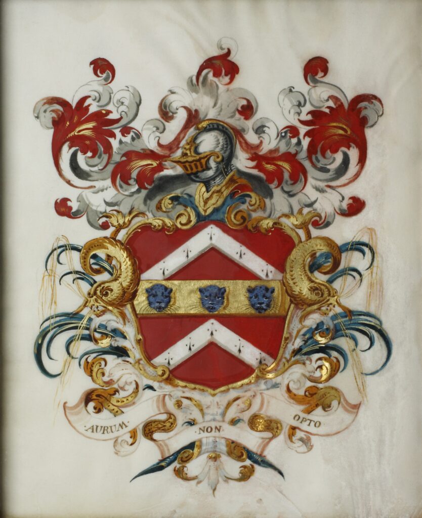An ornate coat of arms with a red shield, white chevron, and blue lion heads, surrounded by decorative scrollwork and a knight's helmet.