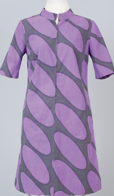 Purple dress with large gray oval patterns displayed on a mannequin.