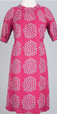 Pink dress with white and light blue floral pattern on mannequin.