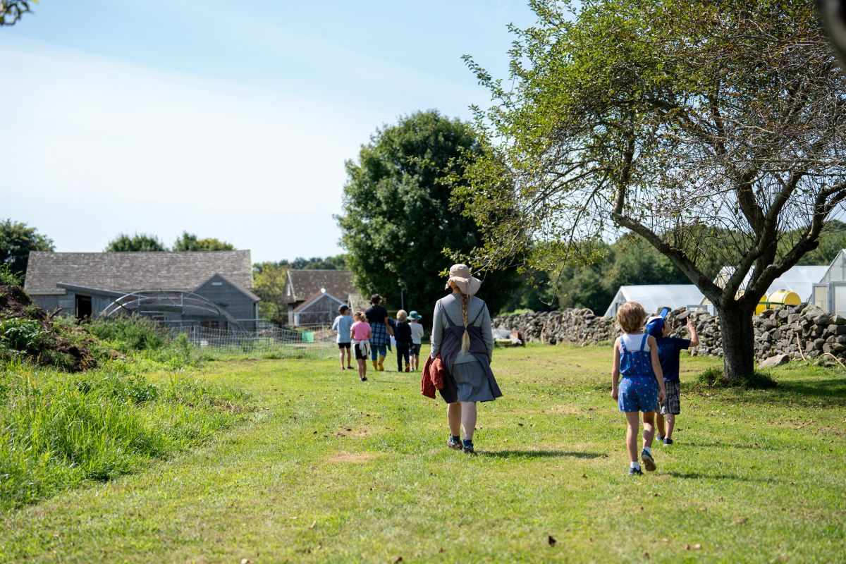 Group of people walking along the edge of fields at Casey Farm.