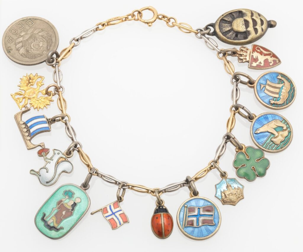 A charm bracelet with various multicolored charms including animals, flags, and figures.