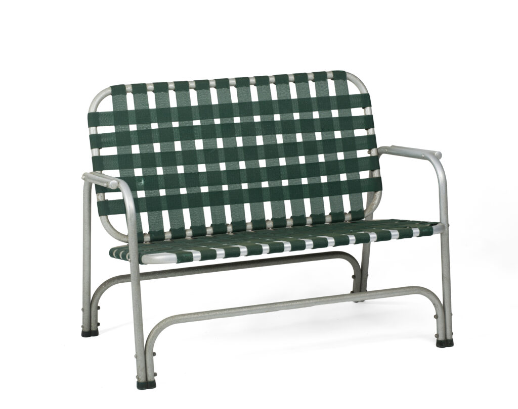A two-seater bench with a silver metal frame and woven dark green straps.