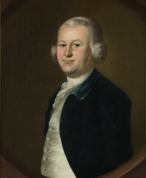 The image is a classic portrait painting of a man dressed in 18th-century attire, including a dark, deep green coat and a white cravat. He has light skin, a rounded face, and is wearing a subtle smile. His hair appears gray and is styled in the typical fashion of that era, with curls at the sides. The background is a muted, dark brown, which contrasts with the subject's lighter clothing and complexion.