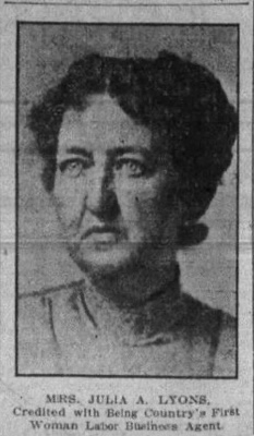 Black and white photograph of a woman with a serious expression, wearing a high-collared garment. Transcribed Text: MRS. JULIA A. LYONS. Credited with Being Country's First Woman Labor Business Agent.