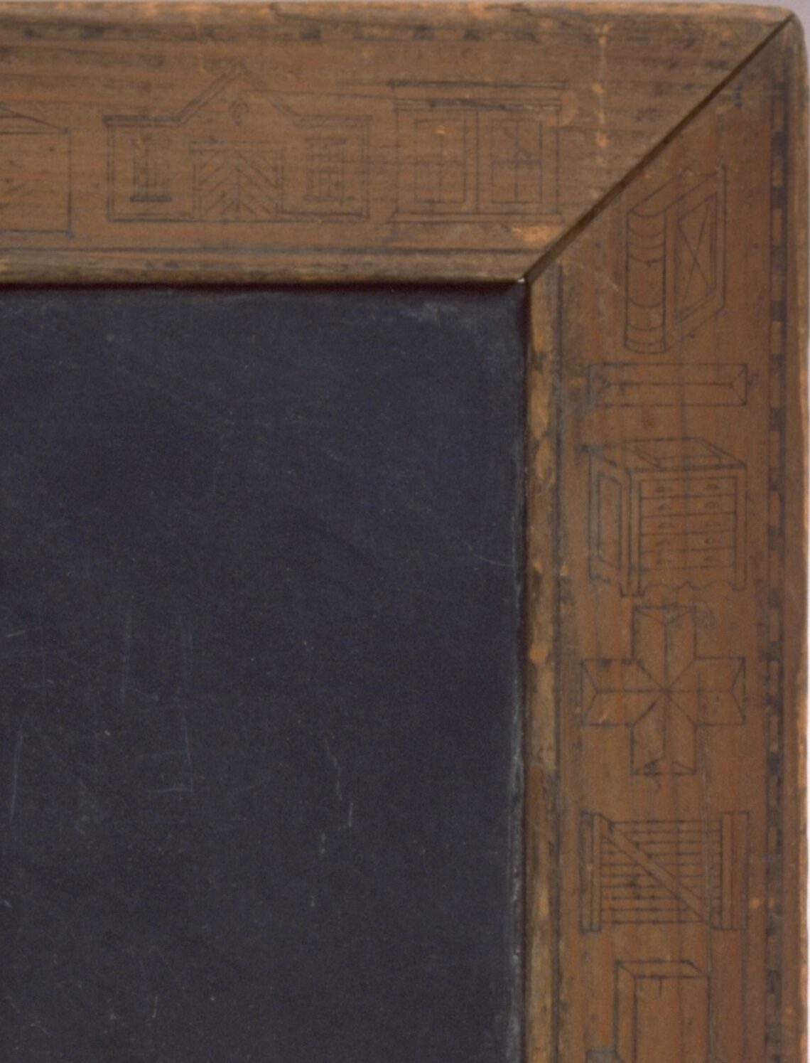 A vintage wooden-framed blackboard with intricate carvings.