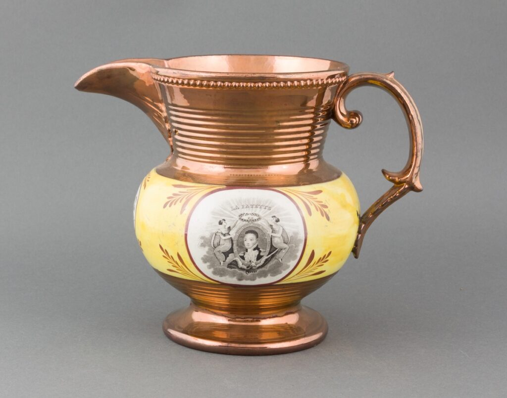 Decorative copper-colored ceramic pitcher with yellow band and black and white illustration. Transcribed Text: "LA FAYETTE."