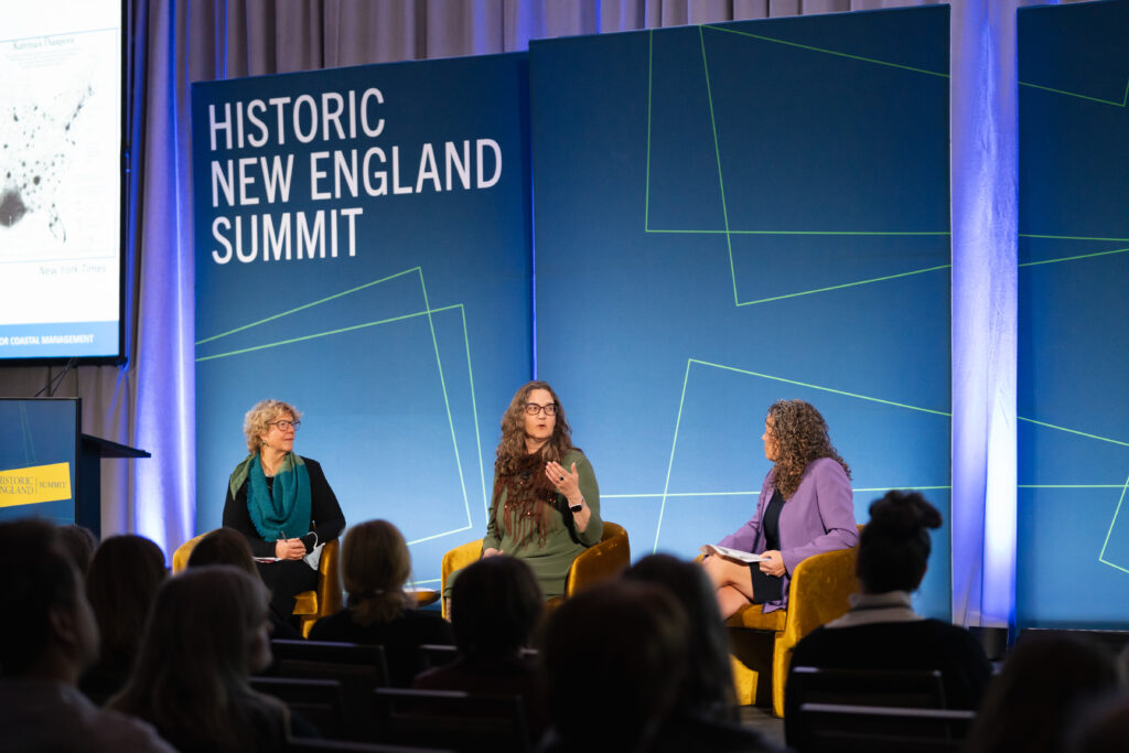 Panel discussion at the Historic New England Summit with three women seated on stage. Transcribed Text: HISTORIC NEW ENGLAND SUMMIT