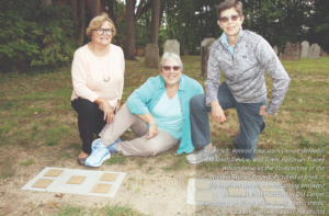 Three women with memorial stones at Old Center Cemetery, West Hartford, honoring enslaved individuals.