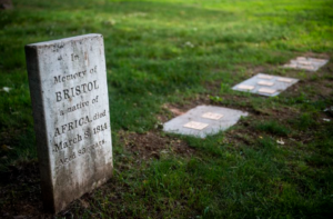 Gravestone of Bristol, native of Africa, died 1814 at 83, surrounded by green grass in cemetery.