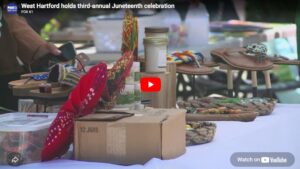 Table with craft items and colorful sandals at West Hartford's third annual Juneteenth celebration.