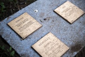 Bronze plaques on a memorial honoring enslaved individuals from the past, symbolizing historical remembrance.