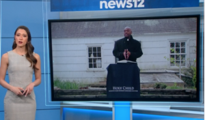 News anchor presents a segment featuring a priest speaking at a podium with Holy Child banner.