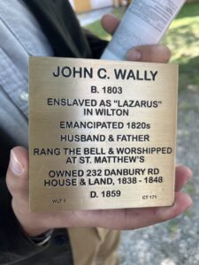 Commemorative plaque for John C. Wally, emancipated in the 1820s, detailing his life and legacy in Wilton.