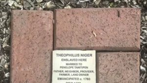 Commemorative brick for Theophilus Niger, highlighting enslavement, emancipation, and legacy as a farmer and landowner.